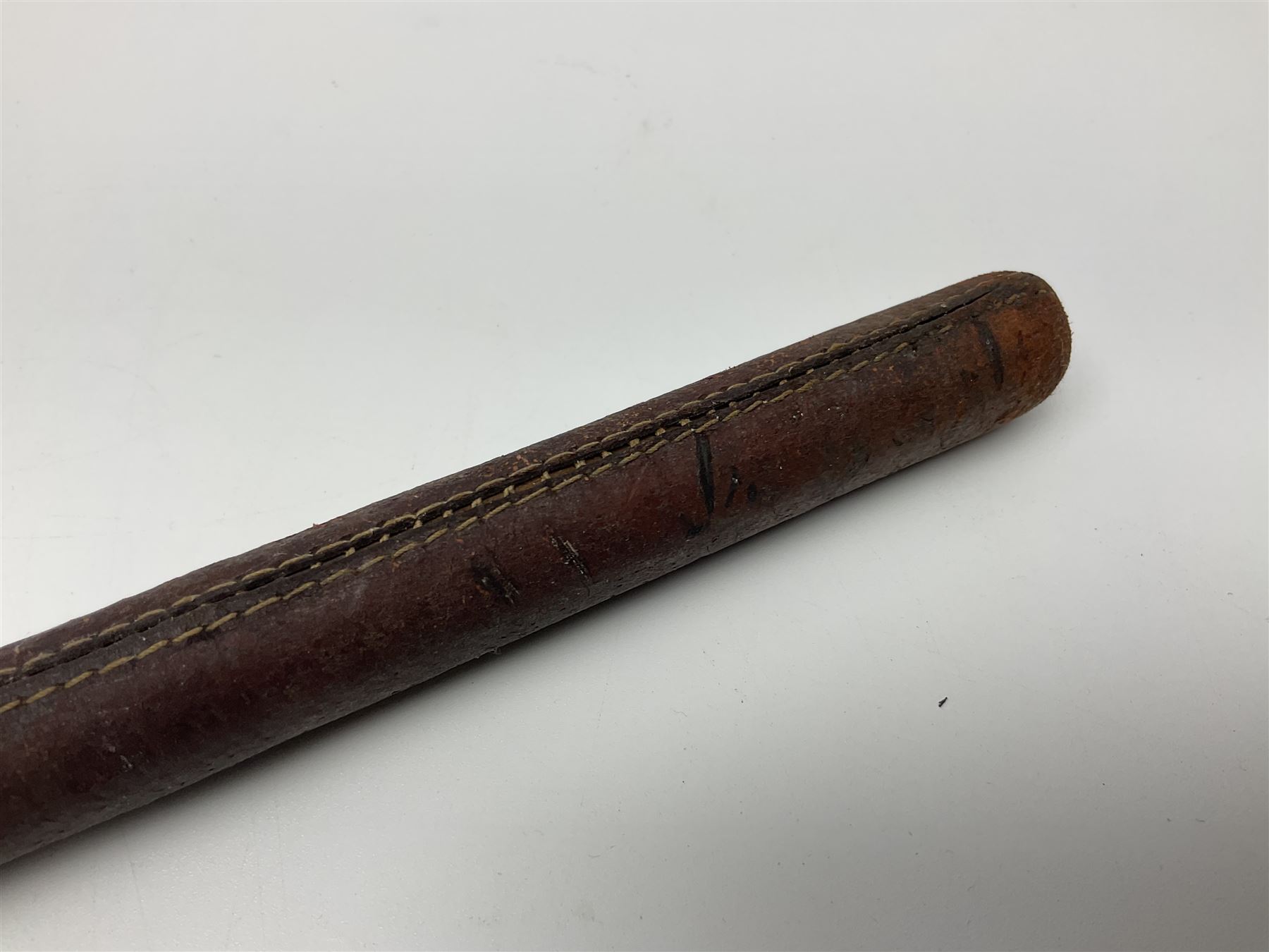 19th century continental folding knife with 15.5cm single edged blade, the pierced brass and iron handle with remains of horn grips L21.5cm overall closed; turned horn handled knife with foliate engraved blade; battlefield relic German 1884/98 knife bayonet; iron spear head; leather covered swagger stick; and two-piece gun cleaning rod