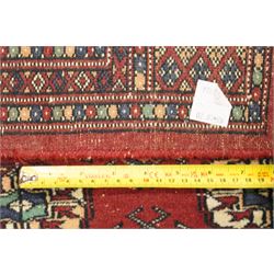 Two hand-knotted rugs, comprising Turkoman Ersari rug and Bokhara rug, Turkoman Ersari hand-knotted rug, terracotta ground with two rows of repeating octagonal guls interspersed with geometric motifs, enclosed by multiple geometric borders, fringed ends, H125cm, W93cm; Bokhara hand-knotted rug, madder red ground with three rows of repeating Tekke guls interspersed with geometric motifs, enclosed by multiple stylised floral and geometric borders, fringed ends, H188cm, W126cm