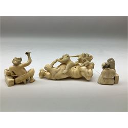 Three carved Tokyo style okimono, 19th century, one carved as a demon with monkeys on his back, with two others carved as men at work, largest example L9.5cm