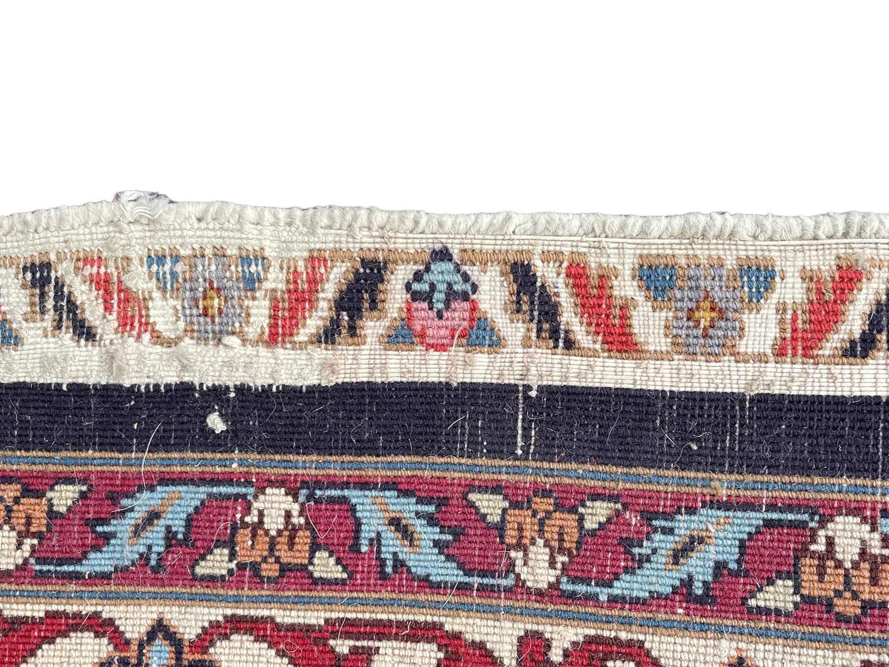 Persian Hamadan indigo ground rug, central floral crimson pole medallion surrounded by trailing foliate decoration and stylised plant motifs, the main guarded border with repeating stylised flower heads, densely knotted