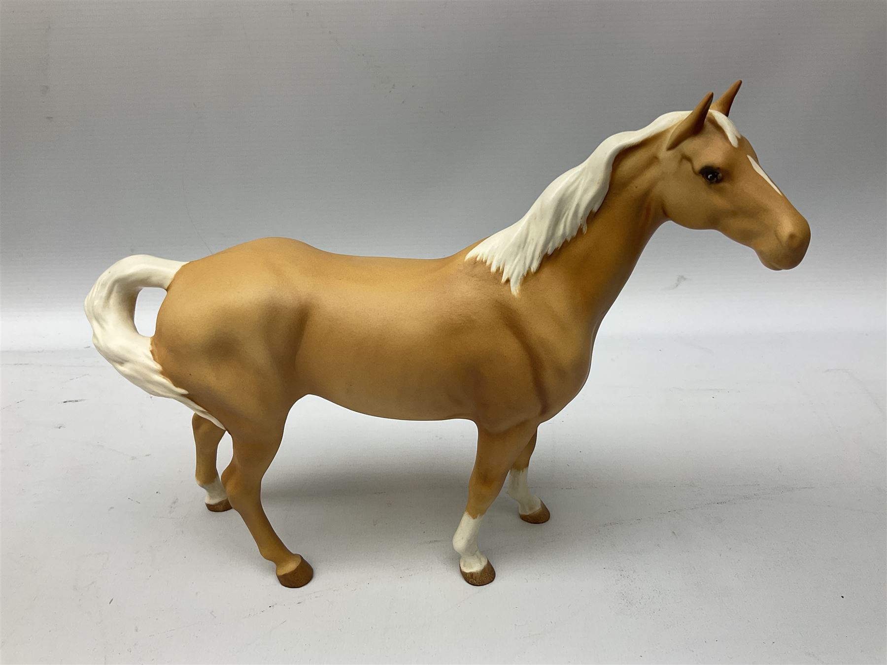 Collection of Beswick horses, including grey horse no.701, palomino foal no 836, grey stocky jogging mare no.855 etc, together two Royal Doulton horses, (8)