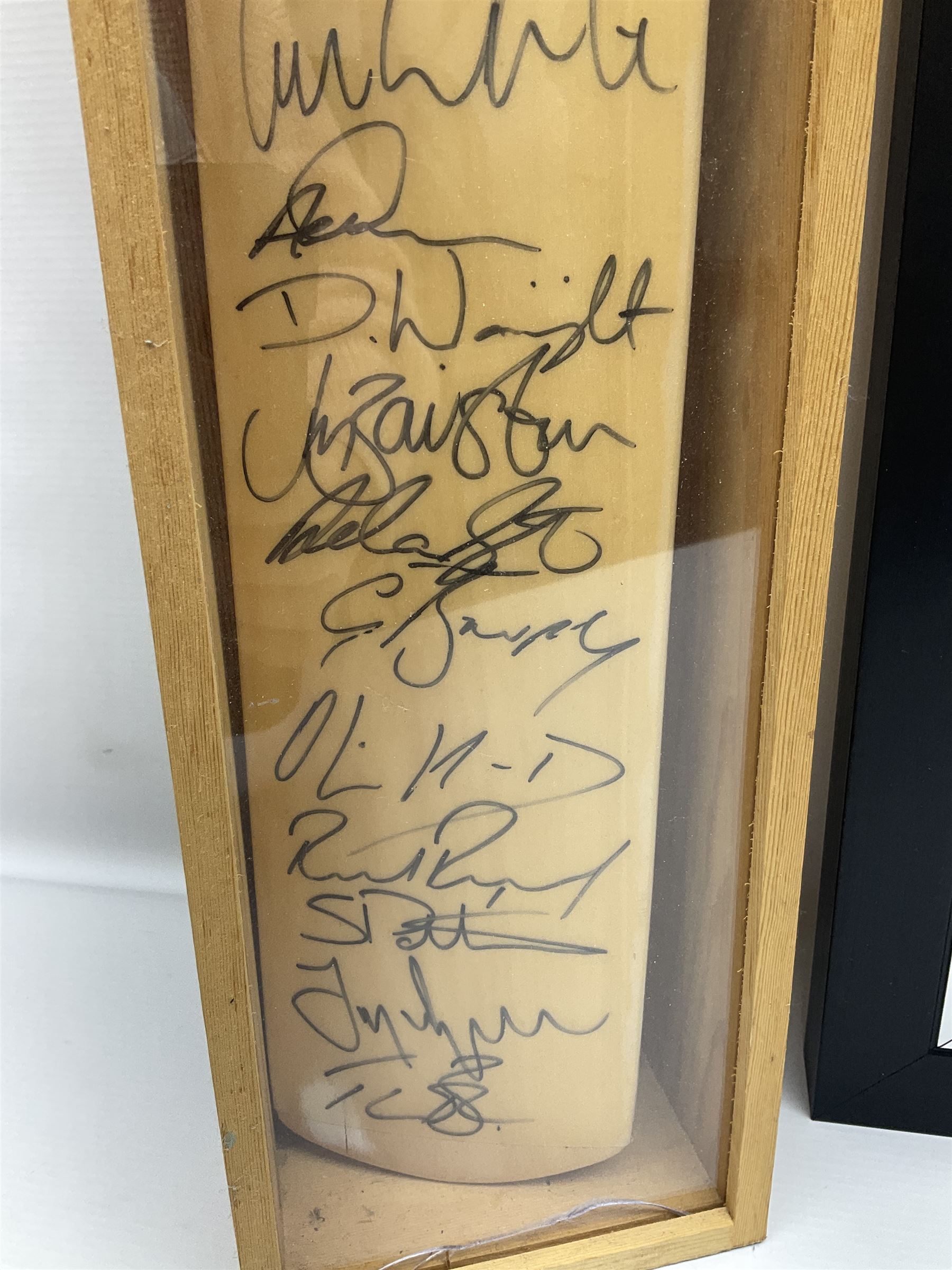 Two signed Yorkshire County cricket bats, bearing signatures including Anthony McGrath, Jacques Rudolph, Michael Vaughn and Matthew Hoggard, etc, both within glazed presentation boxes, box H86.5cm, together with a framed Darren Gough signed presentation print by Gary Keane