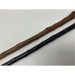 Two wooden walking sticks, both with comparts that would have housed horse measures, H88cm