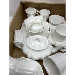 Shelley Dainty White Tea Wares of moulded lobed form, with leaf decoration (Shelley reg no. 272101), including teapot, milk jug, sugar bowl, six mugs, two cake plates etc (41)