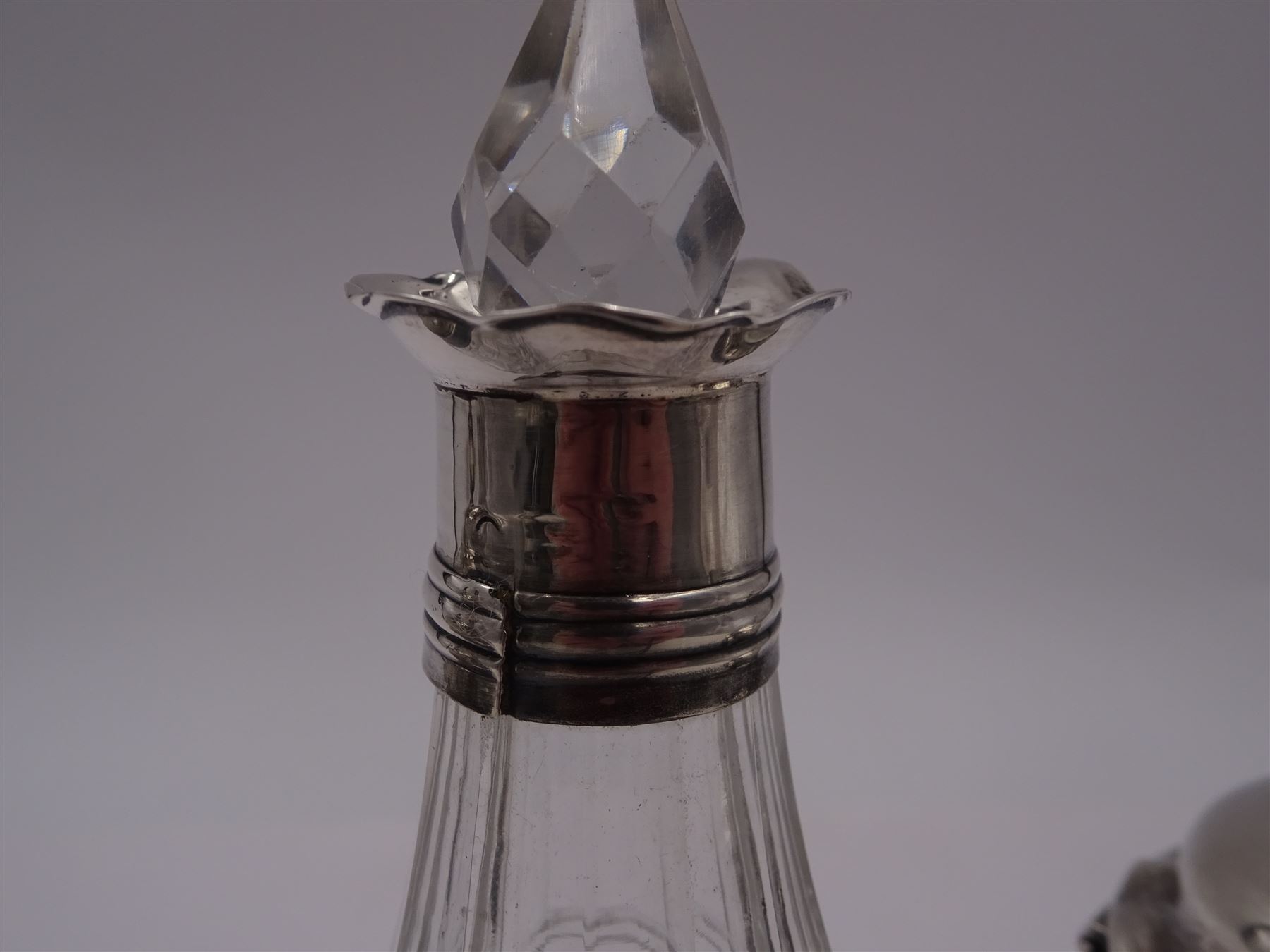 Late 18th century silver cruet stand, of oval form, with pierced sides upon four bun feet, hallmarked to handle Hester Bateman, all other hallmarks indistinct, together with five matched silver mounted cut glass cruet bottles, including some later Victorian examples, hallmarks predominantly indistinct, stand H20cm