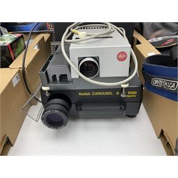 Large quantity of camera equipment in three boxes - Lumix GX1 camera, Canon EOS 500 camera, Lumix FZ100 camera, Pantax  MZ5n, various other cameras, Swift spotting Scope 20 x 60 in box,  Maxtor hard drive, three tripods, Kodak carousel projector, Pradolux slide projector, a selection of camera bags and other camera equipment. 