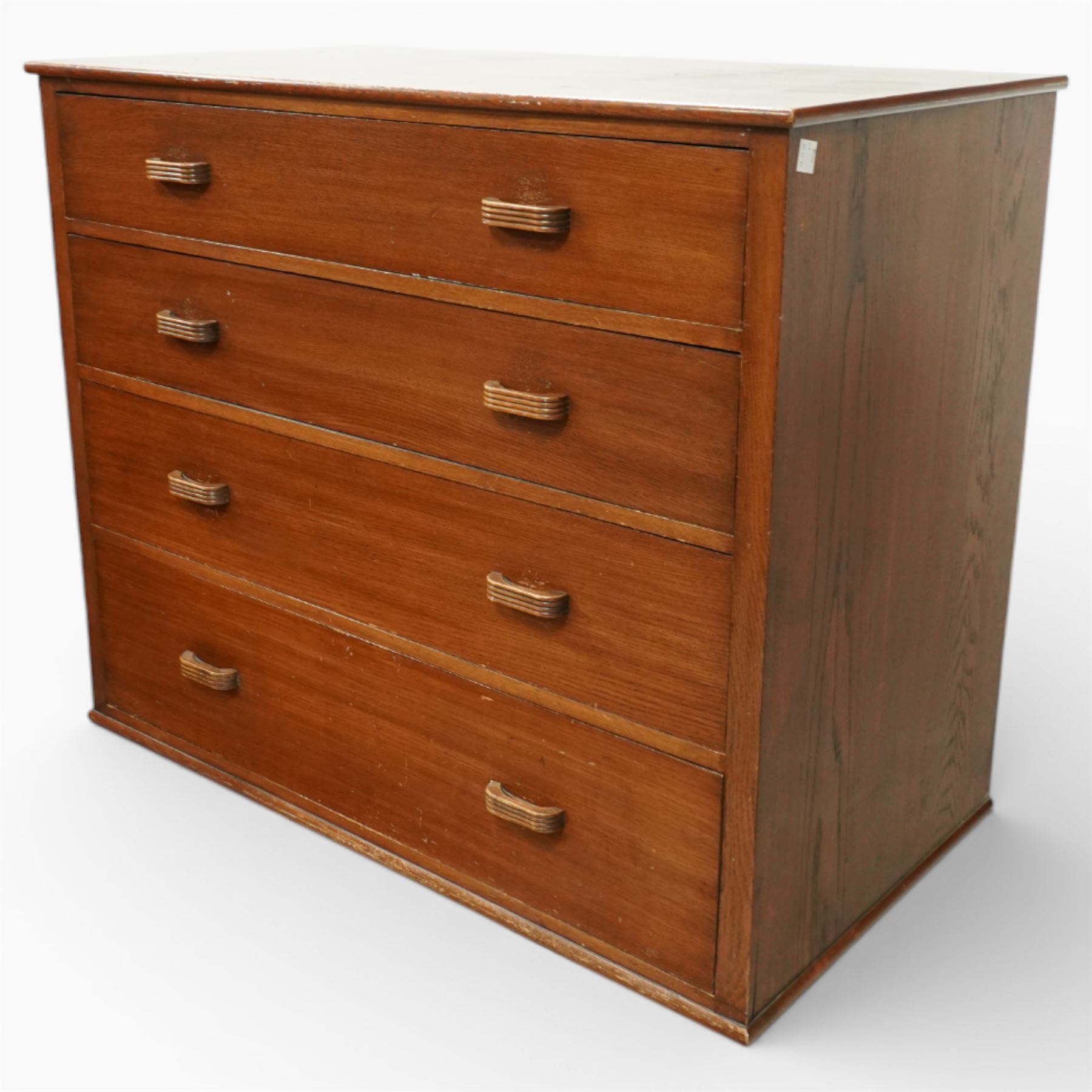 Mid 20th century oak chest of drawers, rectangular top with gently rounded front edge over four graduating drawers fitted with recessed ribbed wooden handles, plain drawer fronts, raised on an integral plinth base