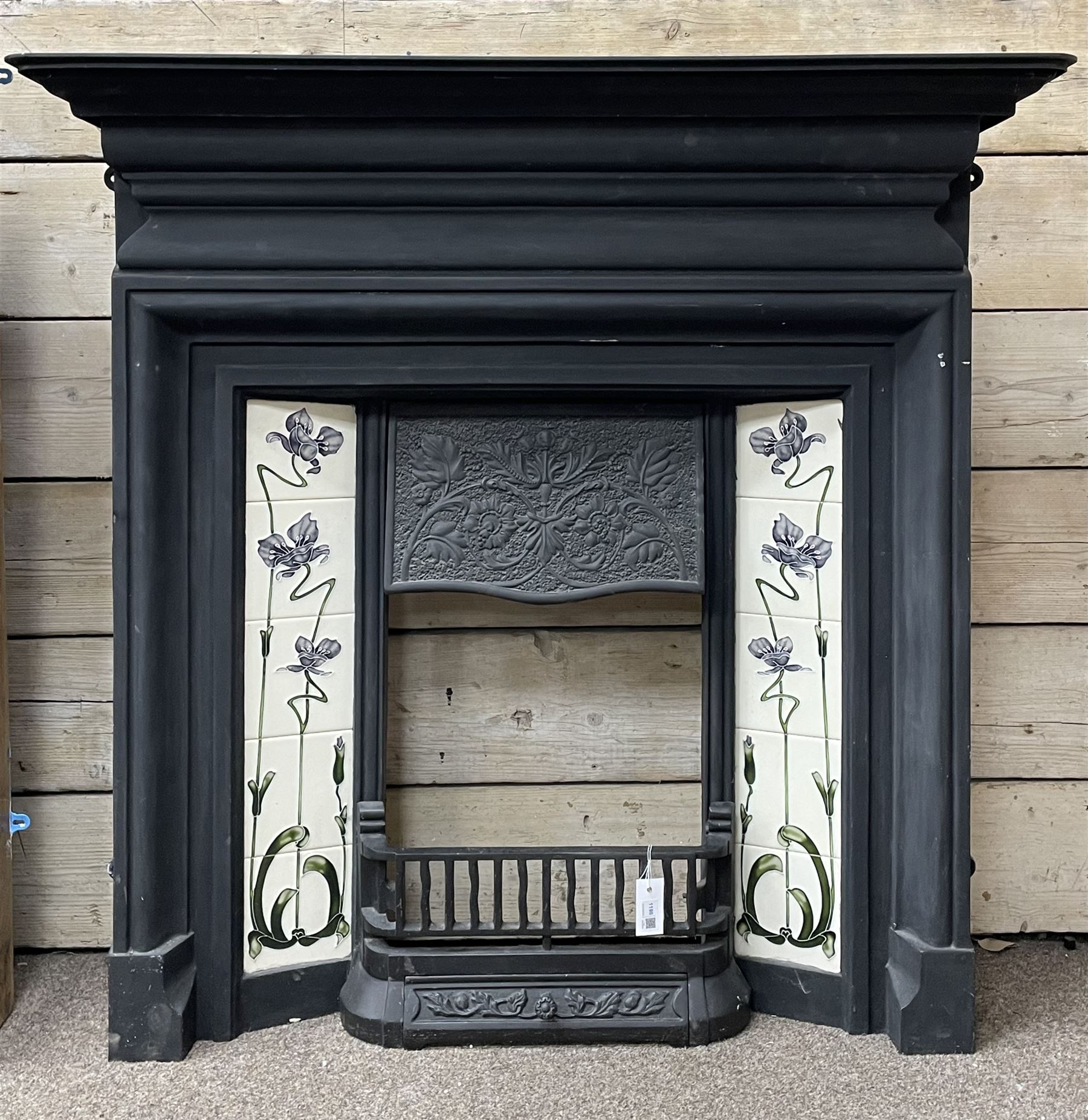 The Gallery Collection Fireplaces - 'Edwardian' cast iron fireplace, the hood decorated with interlacing floral design, with Art Nouveau inspired upright tiles