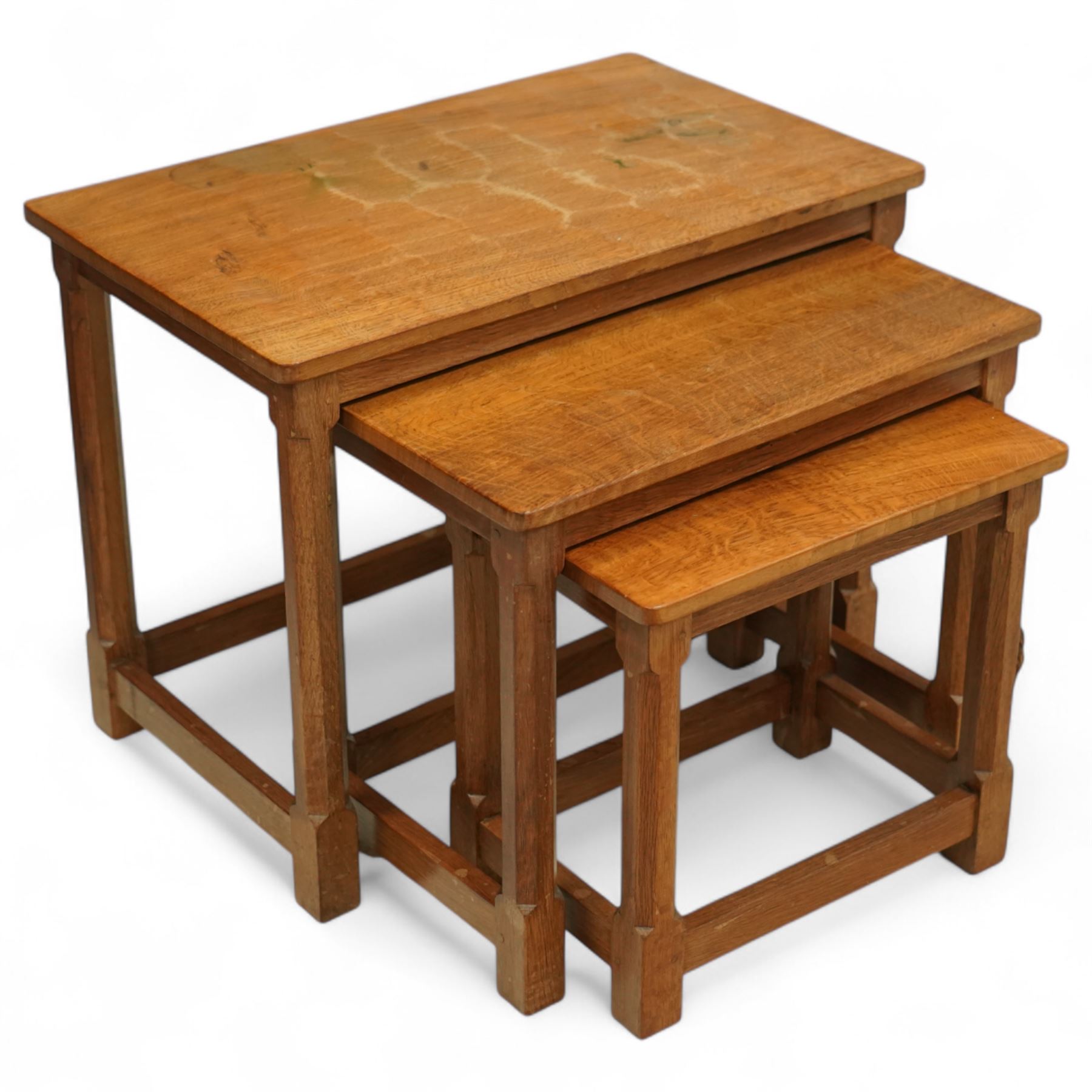 Mouseman - nest of three oak occasional tables, rectangular adzed top, on octagonal supports united by plain stretchers, each carved with mouse signature, by the workshop of Robert Thompson, Kilburn
Largest: Height: 48cm  Length/Width: 61cm  Depth/Diameter: 38cm