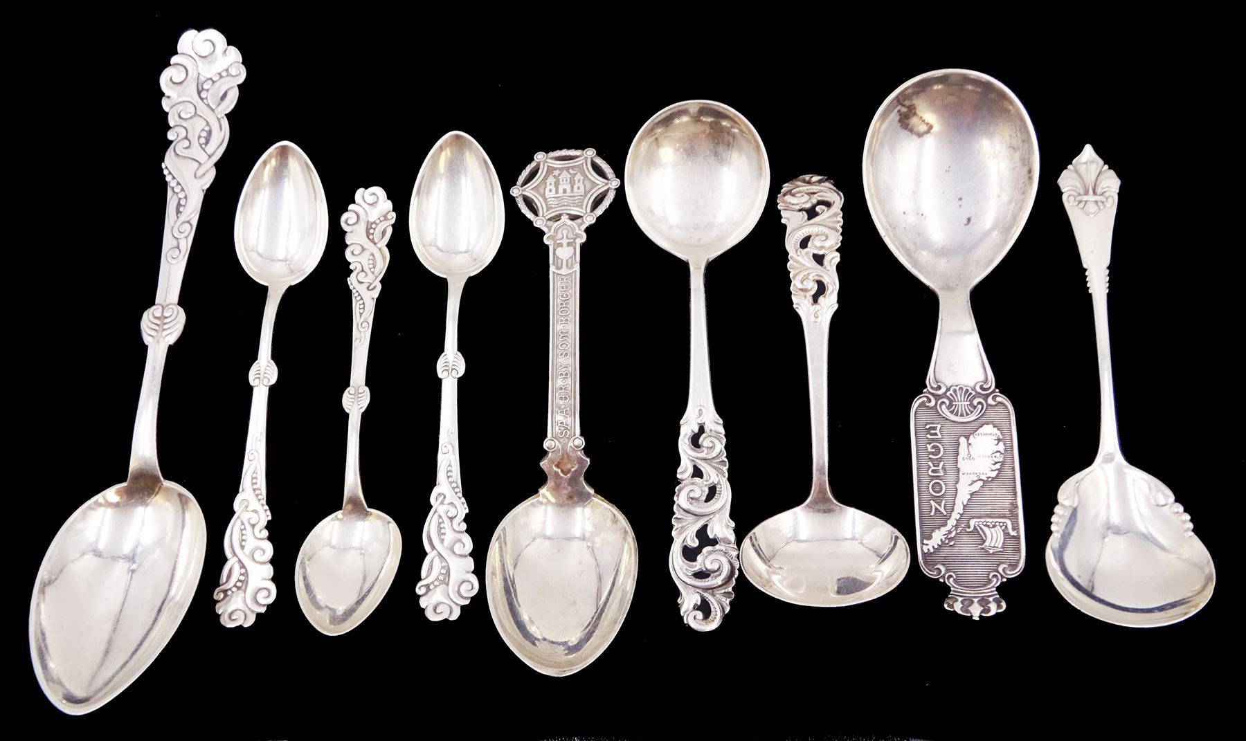 Collection of nine Scandinavian silver spoons, including  early 20th century Danish dessert spoon and three table spoons, each with bead and scroll decoration, stamped with three-tower mark and dated 1916, maker's mark Gronlund, assayer Christian F Heise, together with Norway souvenir spoon, stamped 830s and a Danish commemorative spoon, dated 1910 etc