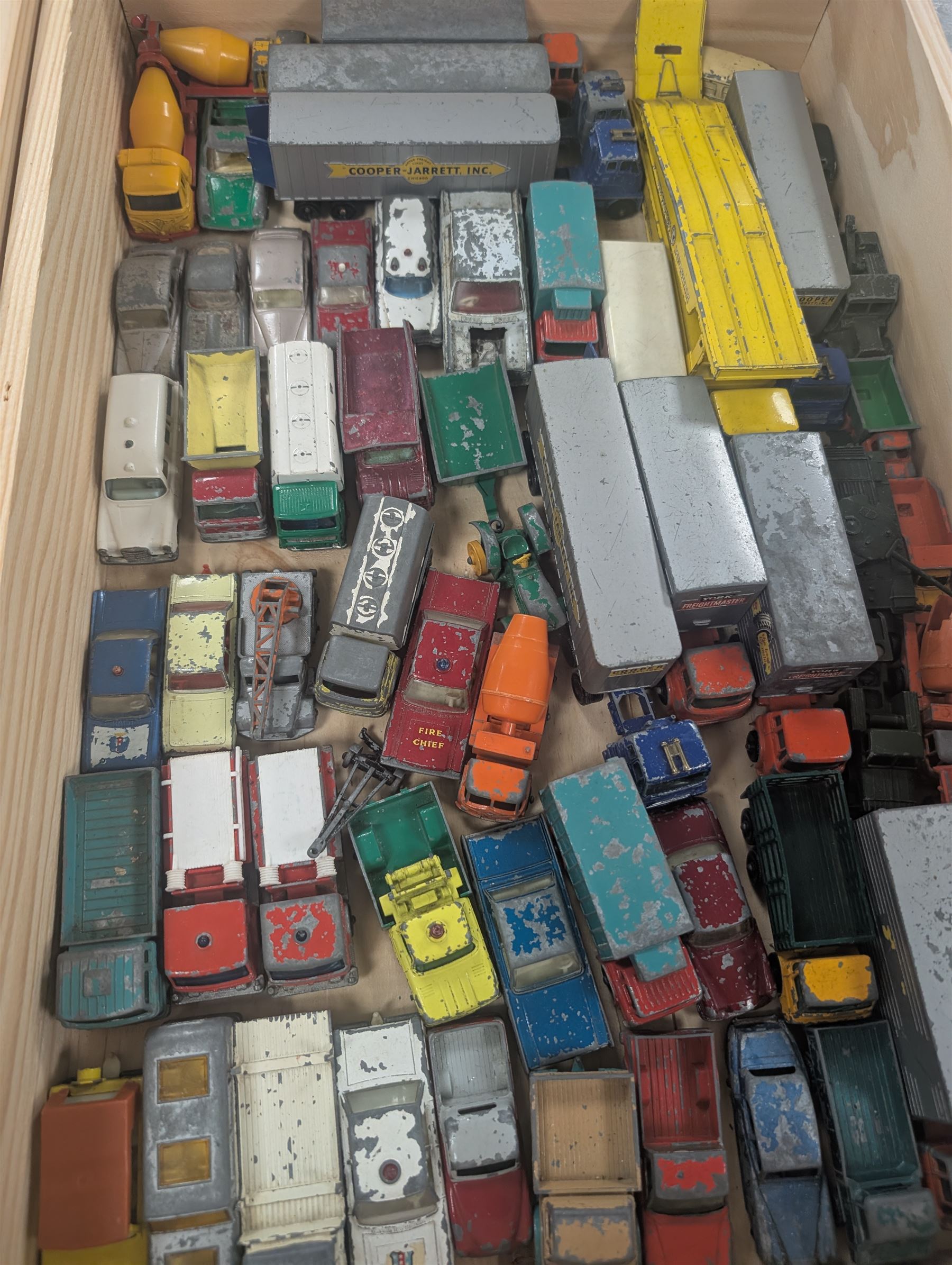 Collection of Matchbox Lesney and similar diecast model vehicles, including buses, lorries, cars, cranes, etc, all loose and playworn, in two wooden wine crates