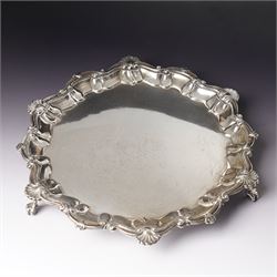 Edwardian silver circular salver with shell moulded pie crust border and ball and claw fee...