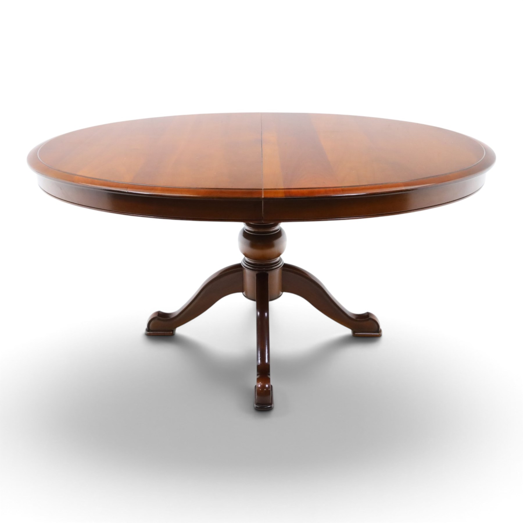 Barker & Stonehouse - cherrywood oval extending dining table and four upholstered chairs, the table with additional leaf extended to cm, raised on a turned column above swept supports, the chairs with brown upholstery and multi-coloured geometric design