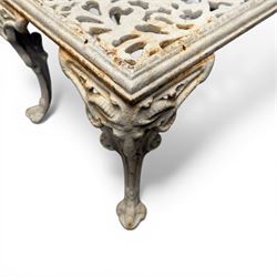 Pair of cast iron low garden tables with rams head legs in a white finish