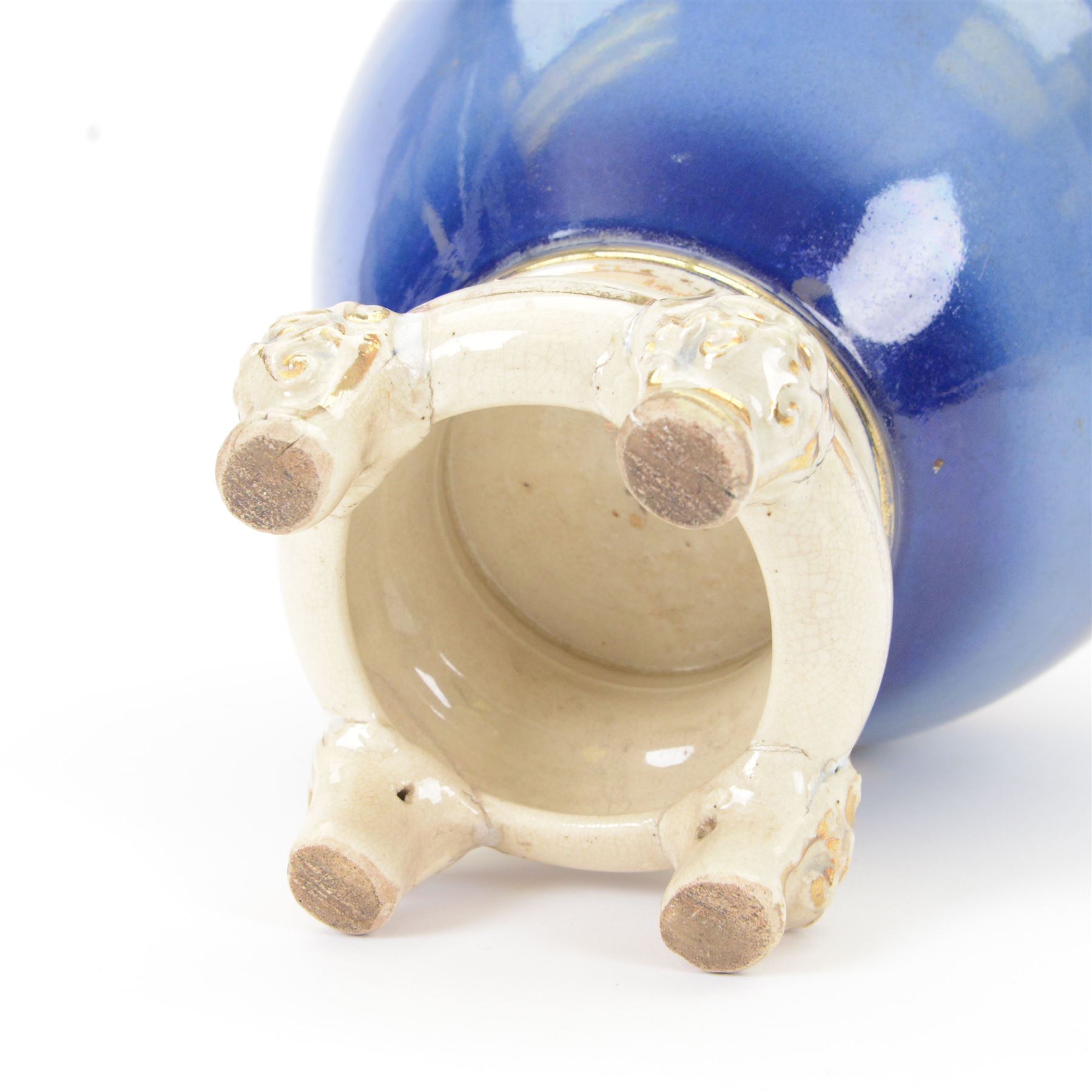 Japanese Satsuma vase, of ovoid form with wasted neck, and three applied mask mounted ring handles, upon four mask detailed feet, the blue ground body painted with blossoming vines, with painted gilt mark beneath, H38cm