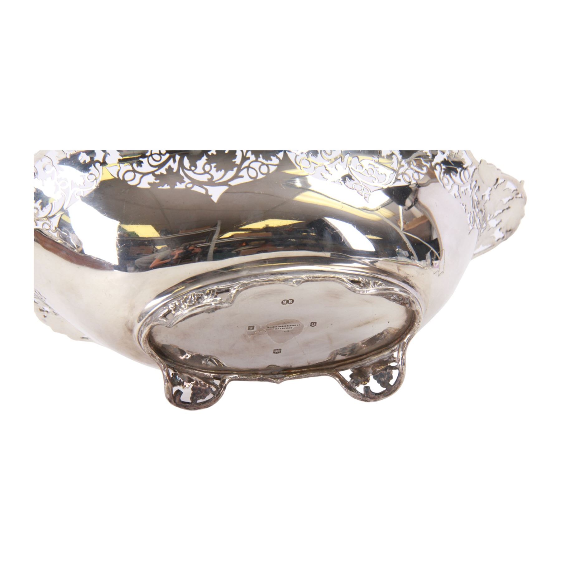 Early 20th century silver bowl, of oval form, the serpentine shaped edge with fruiting vine pierced and applied moulded decoration, upon four conforming fruiting vine feet, hallmarked Manoah Rhodes & Sons Ltd, Sheffield 1931, also bearing impressed mark Manoah Rhodes & Sons Lts Bradford, H11cm L34cm D19cm
