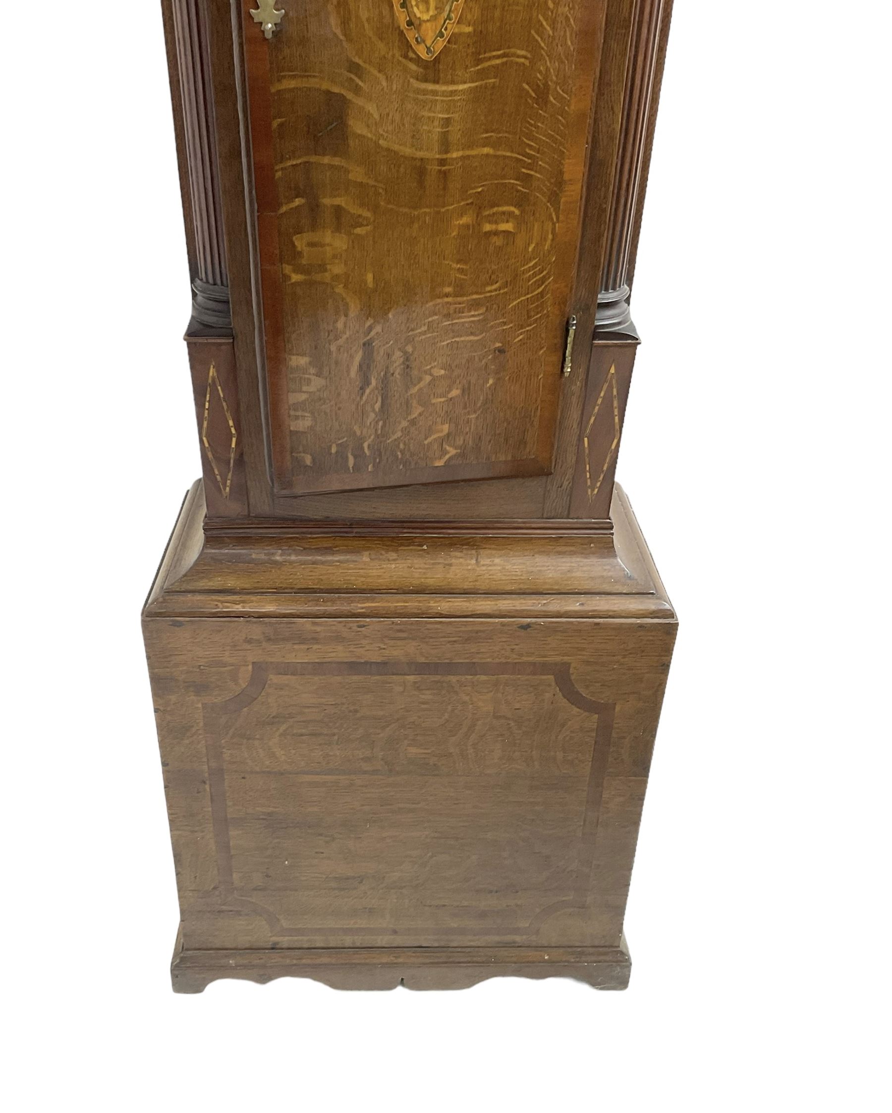 Charles Fletcher of Barnsley - Oak and Mahogany 8-day longcase clock, c 1830, with a swans neck pediment, silk backed open fret work beneath and a break arch hood door, flanked by reeded pilasters with wooden capitals, trunk with reeded quarter columns and a break arch topped door, plinth with inlaid banding on a shaped base, painted dial with Arabic numerals, seconds and date dials, stamped brass hands and painted depictions of the four seasons to the spandrels, dial pinned via a false plate to a rack striking movement with a recoil anchor escapement, striking the hours on a cast bell. With weights and pendulum.