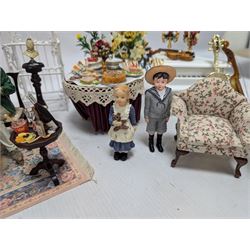Dolls house furniture, including pianos, fireplace, plants, flower arrangements, tables, chairs, six figures and a collection of instruments and other accessories