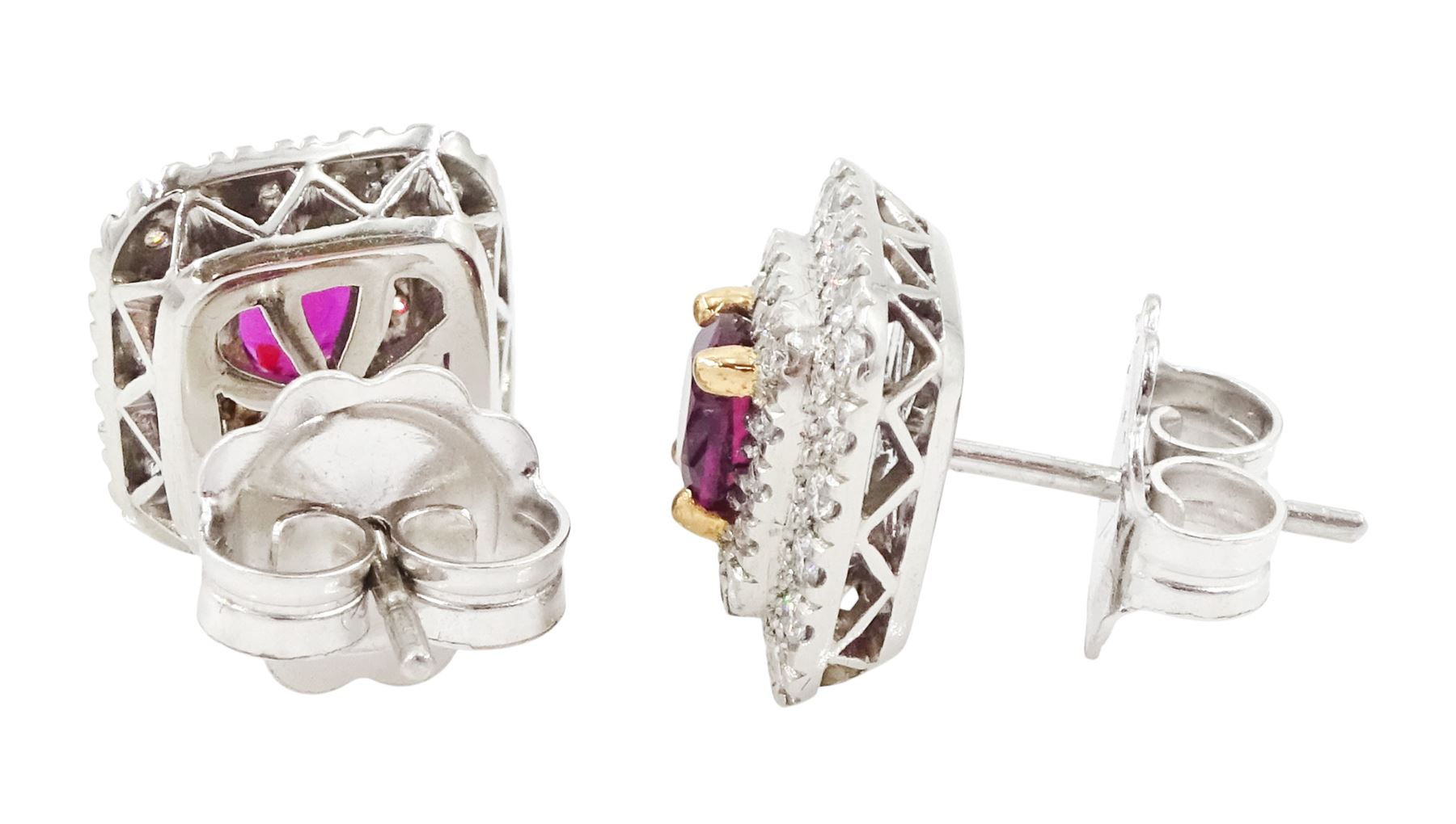 Pair of platinum ruby and diamond cluster earrings, each stud set with a single oval cut ruby in a four claw 18ct rose gold setting, surrounded by two rows of round brilliant cut diamonds, London 2017, total ruby weight approx 1.43 carat, total diamond weight approx 0.76 carat, with Alan Poultney Gems report