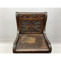 19th Century stained oak chair, possibly a child's box seat, carved with ornate scrolling detail and green man mask to the lift up hinged lid revealing a hidden compartment below the seat, H62cm