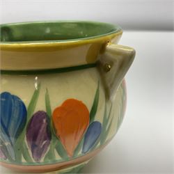 Clarice Cliff Bizarre for Newport Pottery, small bowl in the form of cauldron painted in the Crocus pattern, bordered by brown and yellow banding, with angular handles and raised upon three peg feet, with green printed mark and painted CROCUS beneath, circa 1929, H7cm