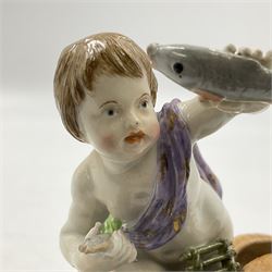 Continental Meissen style figure of a putti fisher boy, in a kneeling pose with fishing trap holding a fish aloft, with spurious mark beneath, H9cm