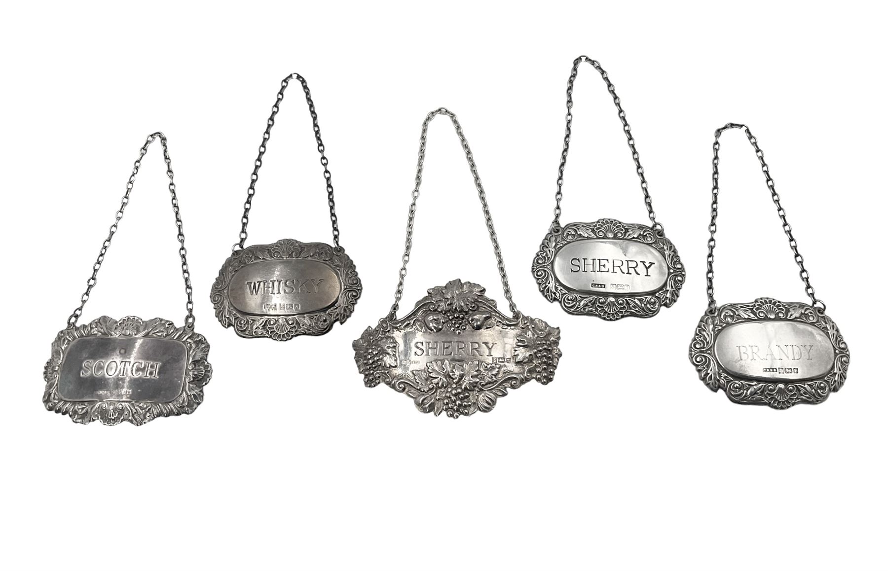 Five modern silver decanter labels, to include three similar Sherry and Brandy examples embossed with scrolls, two hallmarked C Robathan & Son, Birmingham 1989, and one hallmarked Laurence R Watson & Co, Birmingham 1987, together with a scotch example, hallmarked A Marston & Co, Birmingham 1970, and a larger sherry example, embossed with fruiting vines, hallmarked A Marston & Co, Birmingham 1993