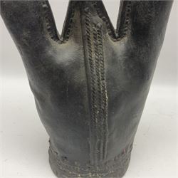 18th/19th century leather water vessel of tapering form, with three varying peaks to the flask's body to include a spout, a shorter triangular shaped peak and the tallest with wood stopper, with large stitched steams throughout, possibly Middle Eastern, H42cm incl stopper