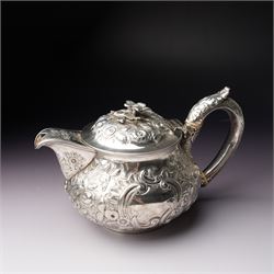 Matched three piece silver tea set comprising teapot of squat circular form London 1827,  milk jug of similar date and sugar bowl with Britannia standard marks, all with later embossed floral decoration and coat of arms, all marks rubbed