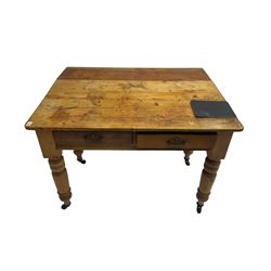 Traditional rustic pine dining table, rectangular top fitted with two drawers, raised on turned tapering supports on ceramic castors