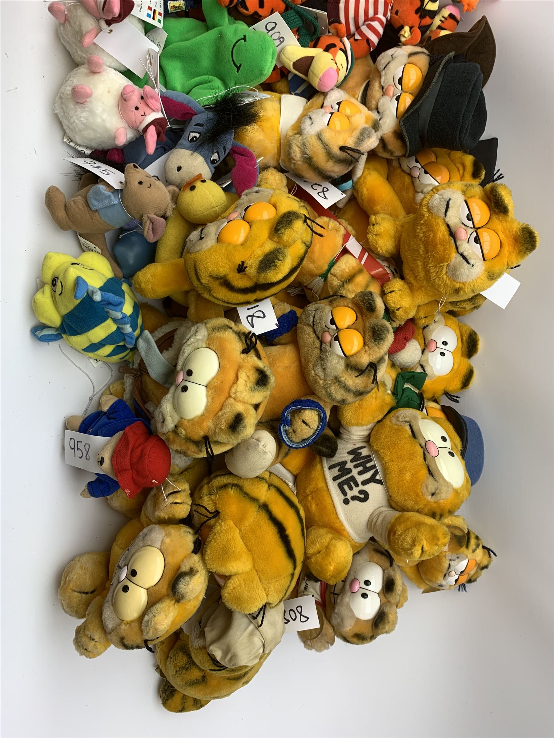 Over forty Walt Disney character soft toys including Tigger Pirate, Xmas Tree, Cowboy, Butterfly, Easter Rabbit etc, Eeyore Santa, Butterfly, Pirate etc, Piglet Lovebug, Valentine, Snowball etc; together with seventeen Garfield the Cat soft toys in various character costume including Skier, Graduate, Aviator, car rear window stickers etc