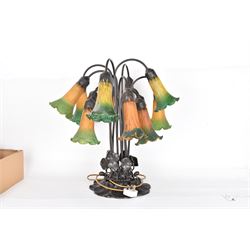 Art Nouveau Tiffany style table lamp, the bronzed base modelled as lily pads leading to tendrils and twelve branches supporting green and yellow glass lily flower shades, H53cm
