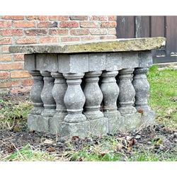 Weathered stone garden table, comprising twenty reconstituted stone balustrades supporting...
