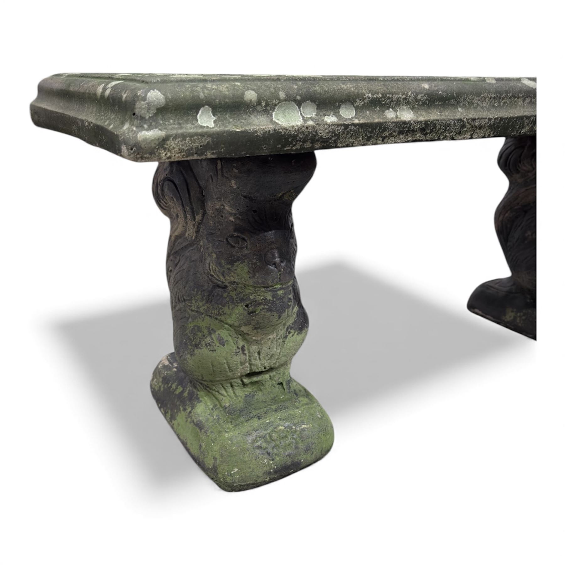Weathered cast-stone garden bench with squirrel designed supports and rectangular top