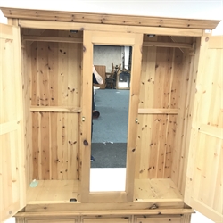 Solid pine triple wardrobe projecting cornice, two doors flanking single central mirror panel above three drawers, plinth base, W157cm, H196cm, D58cm