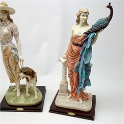 A pair of La Anina Collection figurines, each modelled as a female figure in pink dress supporting a peacock on one arm, and resting the other upon a classical column, H51.5cm, together with another similar figurine modelled as a female figure with hound at her side.   