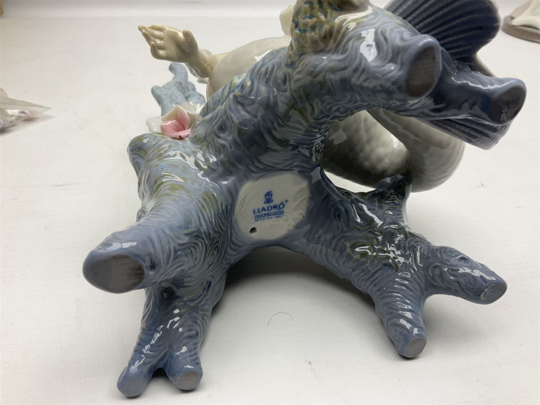 Four Lladro figures, comprising Touch of Class no 5377, Boy Student no 4517, Ocean Beauty no 5785 and Carnival Couple no 4882, largest example H45cm