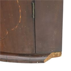 George III mahogany bow-front corner cupboard, projecting moulded cornice over satinwood inlaid frieze with geometric crossbanding, enclosed by twin shaped panel doors with line inlay and ornate brass escutcheon plates, painted interior fitted with shaped shelves, on moulded plinth base