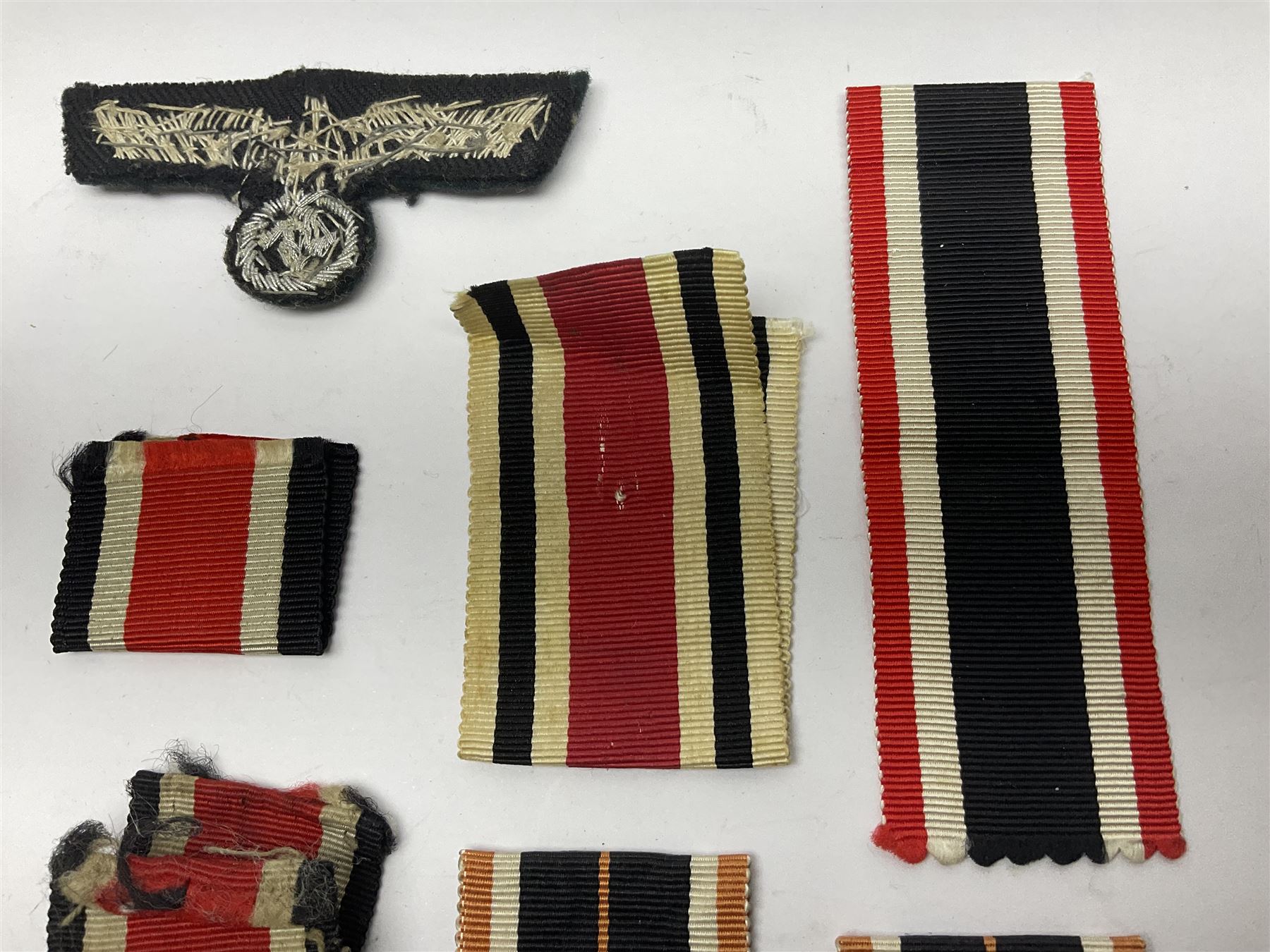 WWII German Iron Cross 2nd Class, the suspension ring stamped 128 for S. Jablonski G.m.b.H. Posen; with ribbon; together with an embroidered cloth eagle badge and quantity of German medal ribbons.