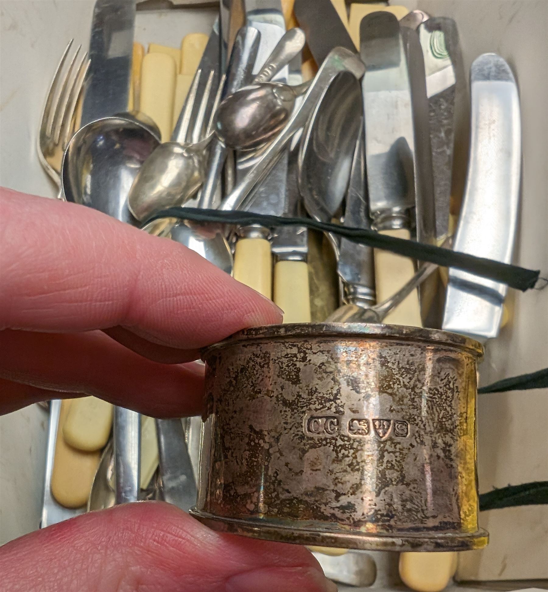 Silver napkin ring and a silver teaspoon, hallmarked, together with a quantity of stainless steel ivorine handled knives and other flatware