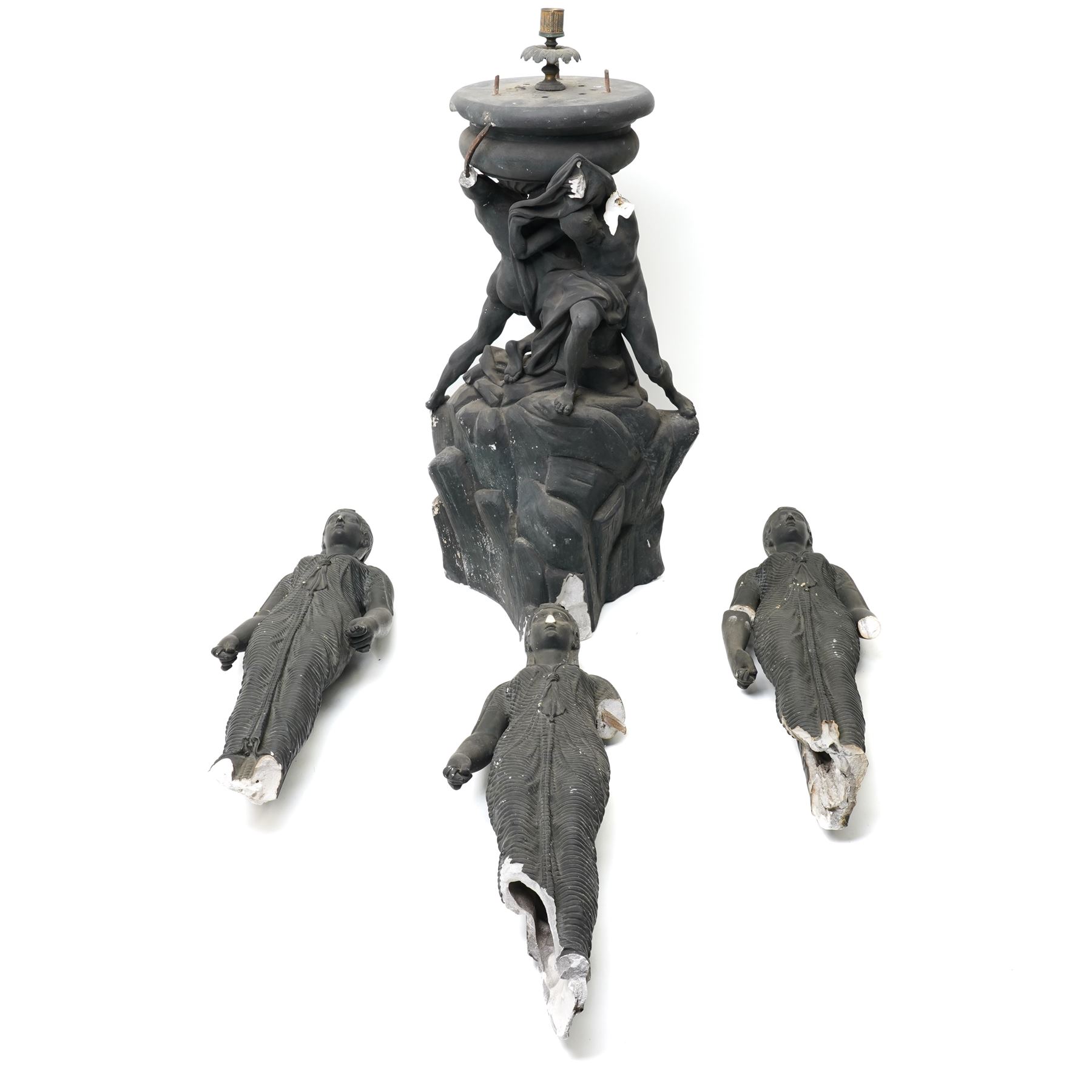 Neoclassical 19th century plaster pedestal, the base cast as two straining Atlantes on a naturalistic rocky base, unmarked, excluding fittings H65cm; together with a set of three plaster figures, cast as Egyptian ladies in headdresses and draped in cloth, by John Dominic Giannelli (1775-1841), the reverse with hieroglyphic decoration, inscribed 'Published as the Act Directed By J D Giannelli 1805', possibly corresponding attachments for the aforementioned pedestal, H62cm 
Provenance: property of a Nobleman