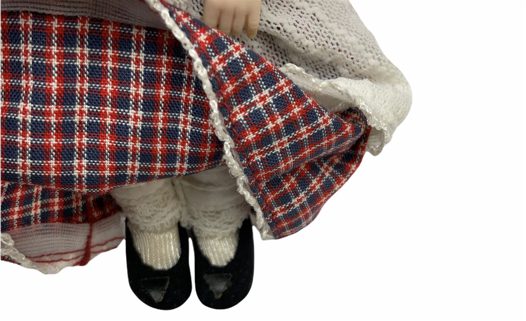 Heidi Ott doll in tartan dress, navy floral dress with white lace and ribbon detailing, striped blue and white dress and a 'Head to Toe' book