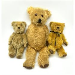 Three English teddy bears c1930s-50s comprising Chiltern wood wool filled Hugmee flat faced bear with swivel jointed head, vertically stitched nose and mouth and jointed limbs with rexine paw pads H12