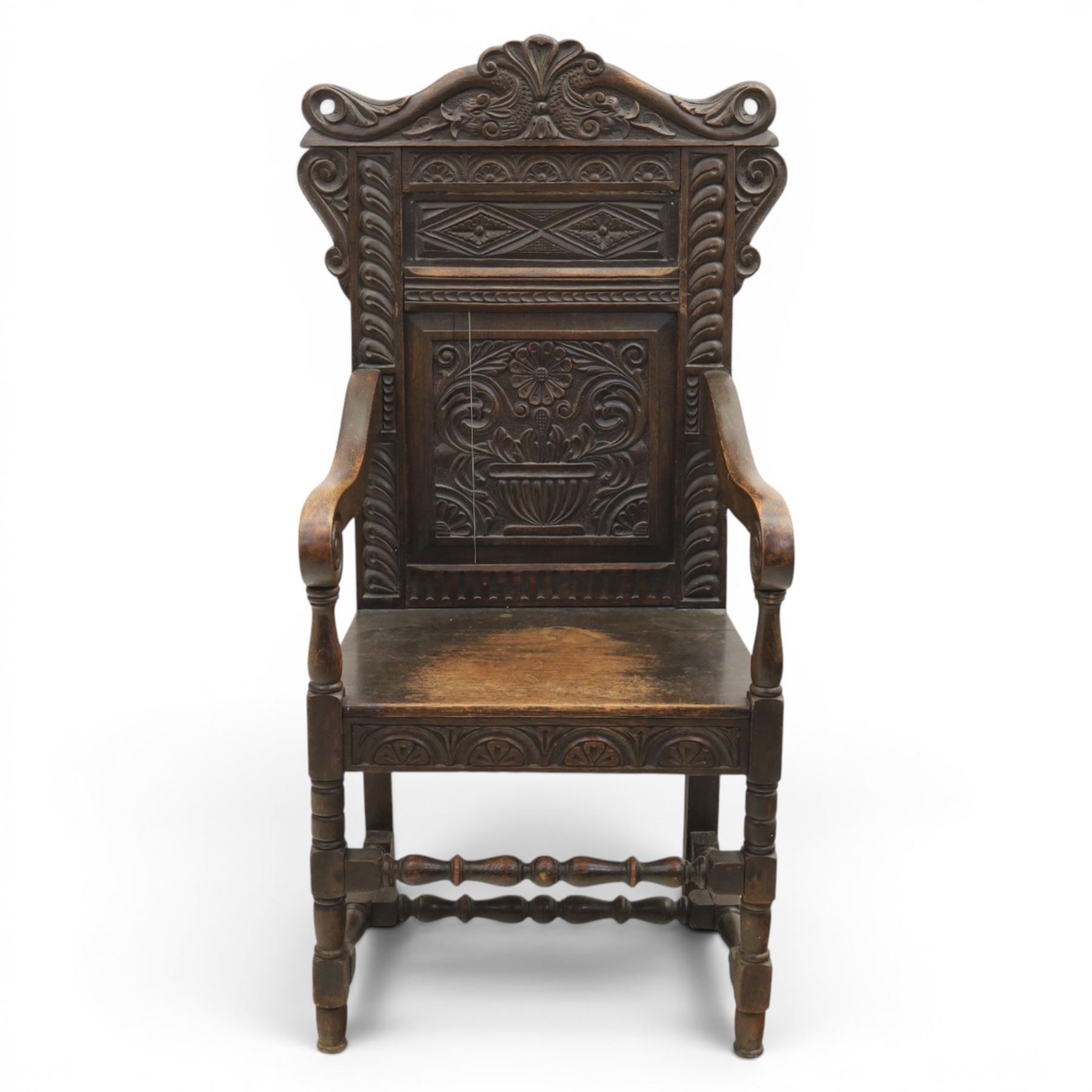 17th century style carved oak Wainscott chair, intricately carved back, united by a turned stretcher