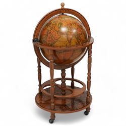 Late 20th century drinks globe, hinged lid enclosing drinks holders, on turned supports