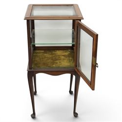 Edwardian bijouterie two tier table, glazed top and sides with inlay surround, glazed door enclosing a single shelf and baized lined interior, raised on cabriole supports