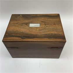 A 19th century rosewood toilet box, with mother of pearl escutcheon and plaque to the hinged cover, opening to reveal a part plush lined and compartmented interior, H7cm L28cm D20cm. 