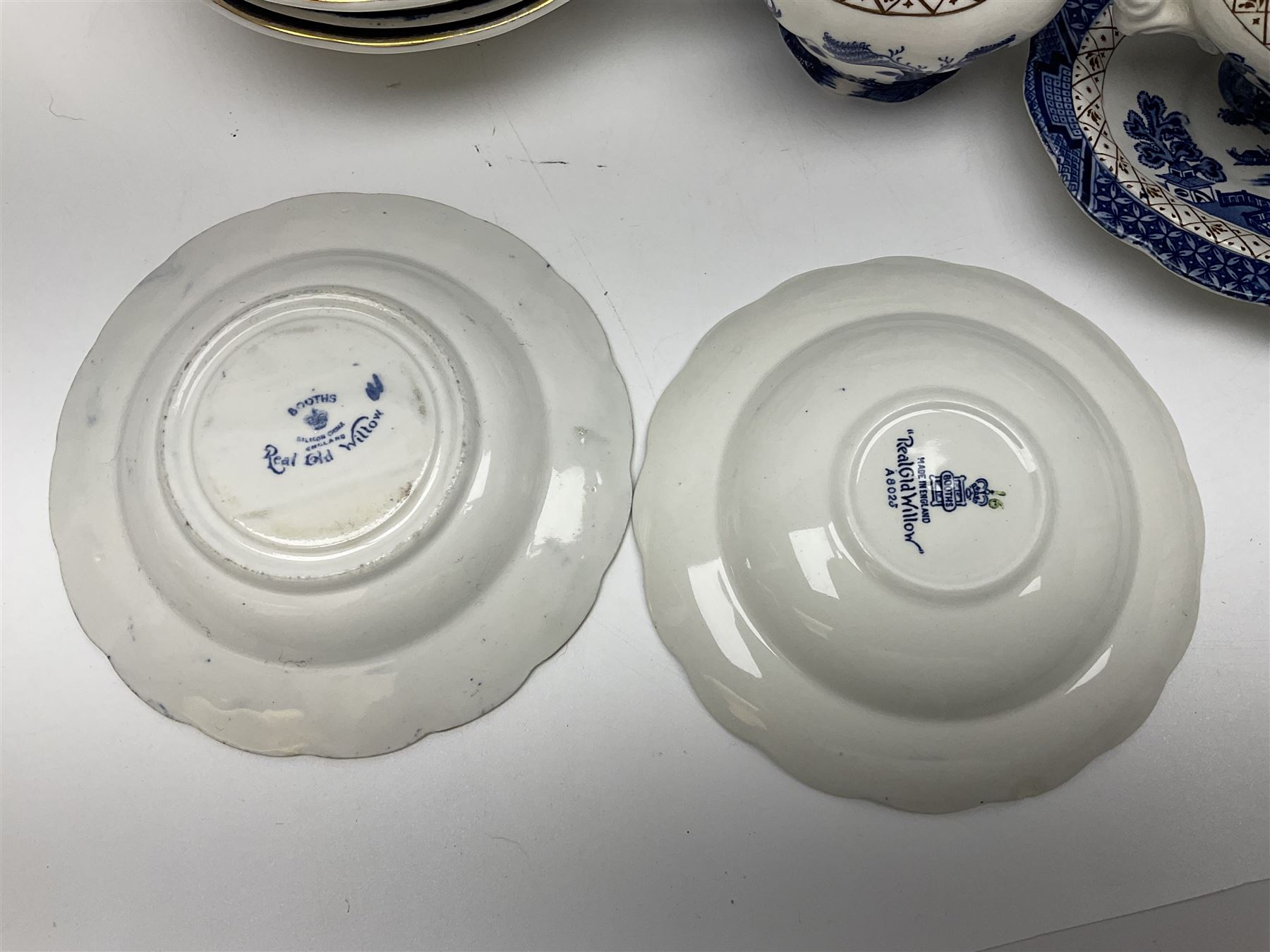 Booths Real Old Willow pattern part tea and dinner service, to include two meat platters, cake stand, teapot, two jugs, sugar bowl, sauce boat, teacups and saucers and a collection of plates and bowls