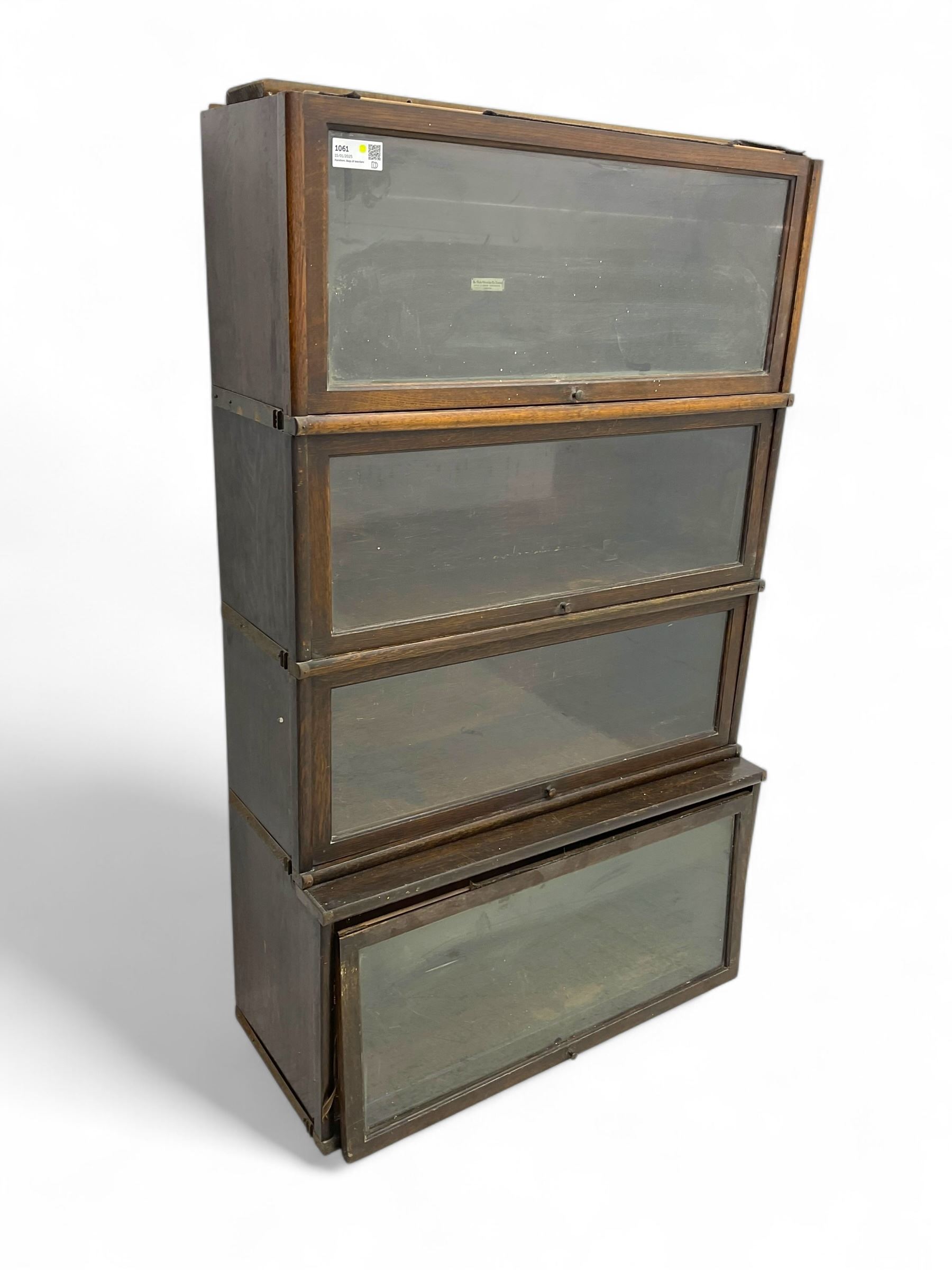 Globe Wernicke - early 20th century oak four-tier stacking library bookcase, four glazed sections enclosed by hinged and sliding doors