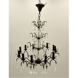 Contemporary bronze finish twelve branch chandelier, decorated with glass droplets 